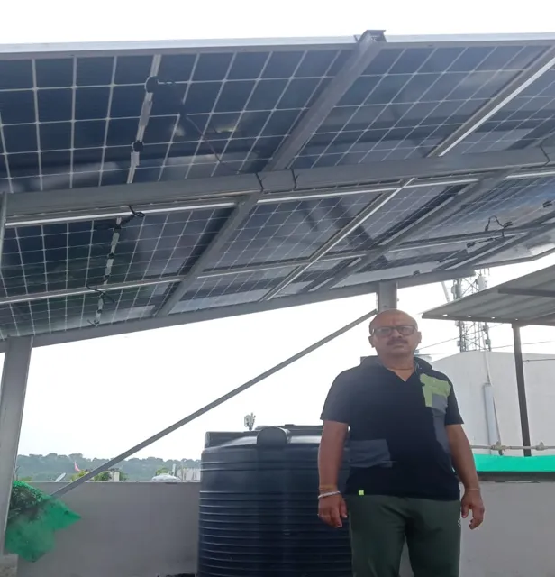 Laxmi Kant Pal with the 3.3 kW rooftop system